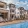 Resort-style pool with tanning shelf and lounge seating by apartment building